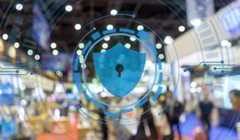 a blurred photo of a tradeshow with an overlay of a blue lock graphic and technical-looking lines and circles